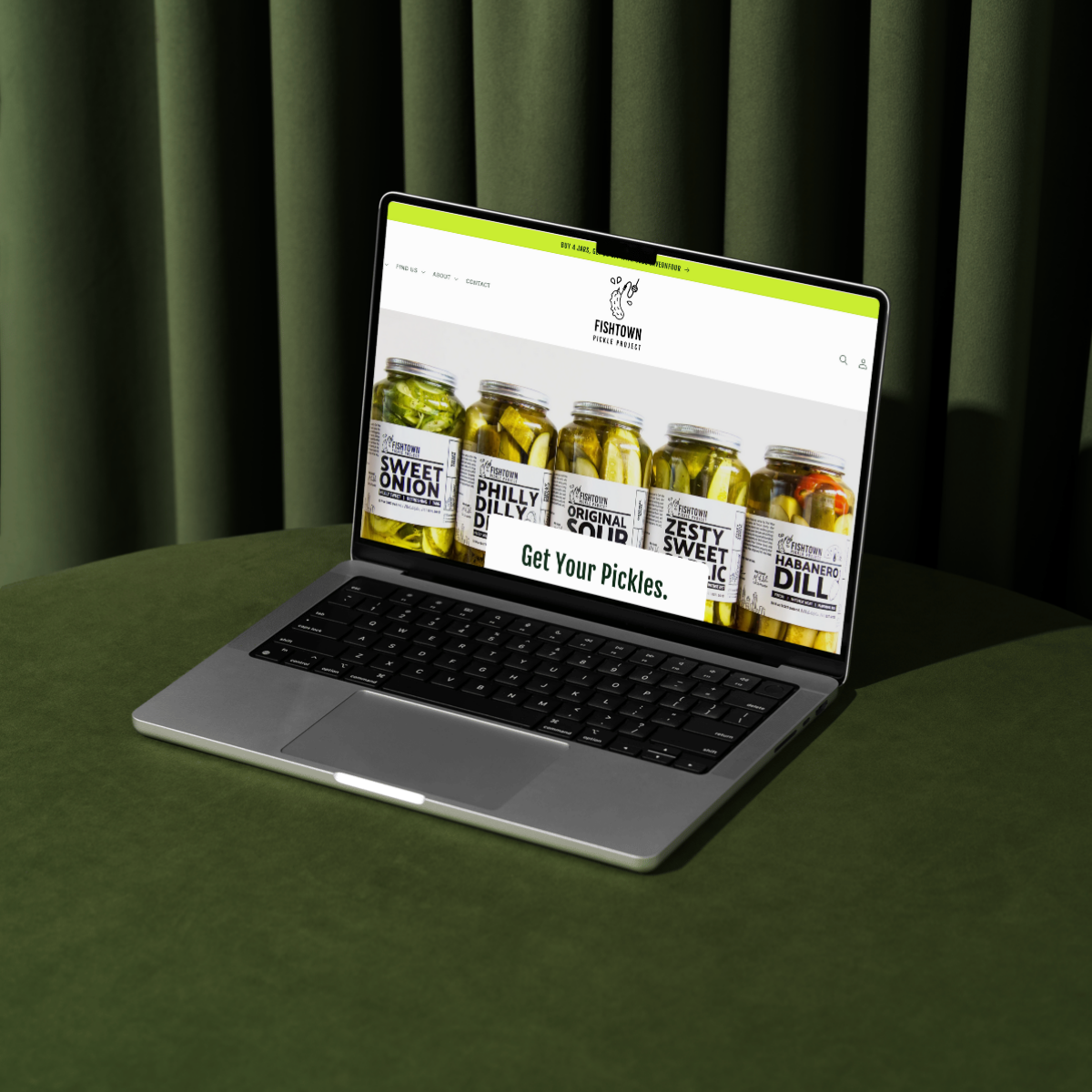 A modern laptop featuring an UX-optimized ecommerce website for Fishtown Pickle Project, displaying artisanal pickles. Website design done by Next Chapter Designs, an ideal partner for food brands and small businesses seeking expert ecommerce website design and email marketing consulting.